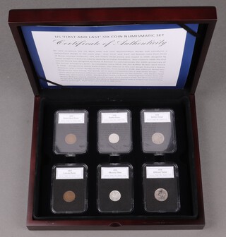 A collection of 6 American silver and bronze coins contained in plastic slabs and within a mahogany box 