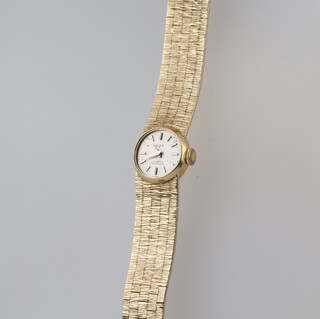 A lady's Swiss 17 jewel wristwatch, the silvered dial marked W of S, 17 jewels Nicabloc, movement signed Swiss 17 jewels, contained in an 18ct gold case with integral bracelet, 32 grams excluding movement and glass 