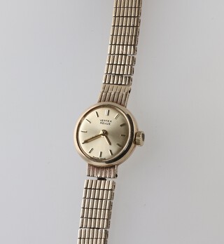 A lady's Vertex Prevue wristwatch with champagne dial and batons, the movement signed Vertex MSR 17 jewels, contained in a 9ct gold case with integral bracelet, 15g excluding movement and glass 