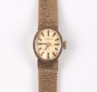 A lady's Longines wristwatch with gilt dial and batons, the movement  signed Longines Watch Company Swiss, 17 jewels, 5603 55036412, contained in a 9ct gold case with integral bracelet, 21g excluding movement and glass 