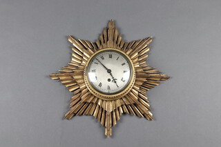 A 1920's Sunburst wall timepiece with 15cm silvered dial, Roman numerals contained in a carved gilt sunburst case, 46cm 
