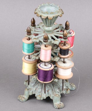 A Victorian verdigris metal 2 tier bobbin stand with various bobbins, on claw supports 22cm h x 11cm 