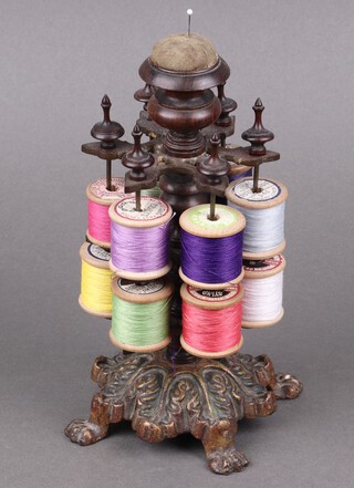 A Victorian revolving gilt metal 2 tier bobbin stand, on paw supports 24cm x 11cm 