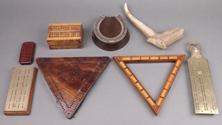 A stag horn cribbage board marked Banff Canada, an triangular inlaid mahogany cribbage board, an oak and steel cribbage board in the form of a horse shoe and 3 other cribbage boards 