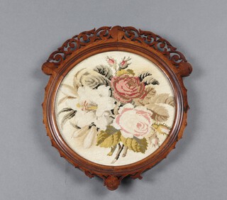 A Victorian circular wool work panel of roses, contained in a carved and pierced rosewood frame 30cm 