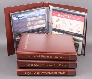 Four albums of Elizabeth II GB first day covers and presentation stamps 