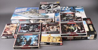 A collection of mainly vintage jigsaws together with models to include 3 Return of The Jedi jigsaws (Veda, Jabba's Palace, Internal Millennium Falcon, 3 Star Wars jigsaws (Chewbacca and Han Solo, C3PO and R2D2, Internal Millennium Falcon, a MPC model kit of a TIE Interceptor (not guaranteed complete), an MPC model of Darth Vada's TIE Fighter (not guaranteed complete) and a Star Wars Episode One 300 piece jigsaw 