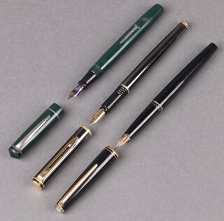 A Mont Blanc fountain pen with 585 gold nib, a Waterman fountain pen in a polished steel finished case and a Unique Junior fountain pen in a green vase 