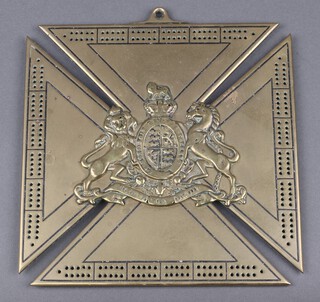 A Victorian brass inkwell in the form of a cross decorated Royal Arms to the centre 22cm x 22cm 