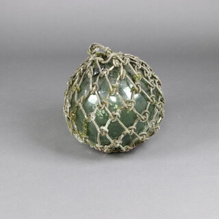 A large green glass fishing float 30cm diam. 