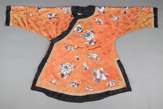 A Chinese late 19th/early 20th Century lady's orange silk and embroidered tunic