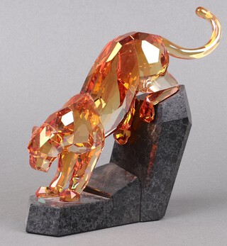A Swarovski Crystal  2011 figure of a panther - Orange Shine on a polished granite base, from The Power of Elegance Collection 18cm, boxed and with certificate 