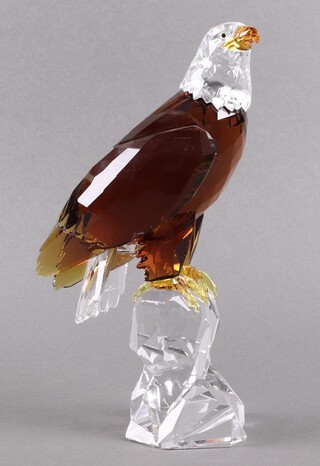 A Swarovski Crystal Wattens 2011 figure of an eagle - Bald Eagle perched on a rugged rock 20cm, limited edition of 10,000, complete with certificate, booklet and hard carrying case 