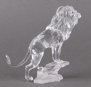 A Swarovski Crystal  2008 figure of a lion standing on a rock 11cm, boxed 