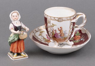 A Meissen cabinet cup and saucer with panel decoration depicting romantic scenes, the base impressed 75 and with cancellation mark (cracked), together with a German porcelain figure of a standing girl 11cm 