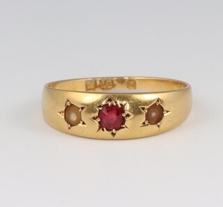 An 18ct gold ruby and pearl set ring, size L 1/2, 2.8g