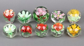 Ten floral decorated glass paperweights 