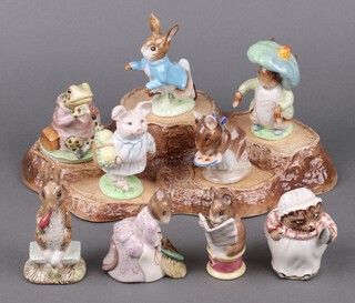 A collection of  Beswick Beatrix Potter figures - Benjamin Bunny, Jeremy Fisher, Peter Rabbit, Hunca Munca dated 1997, all with gold stamps to their bases, together with 5 Beswick figures - Mrs Tiggy Winkle, Fierce Bad Rabbit 1977, Appley Dapply, Tailor of Gloucester (af), Little Pig Robinson (chip to ear) and a Beswick tree stump display stand 