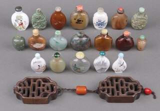 Two Chinese bronze snuff bottles and 17 others, together with Chinese pierced and carved hardwood panels 