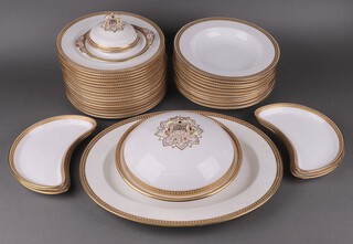 A 38 piece Copeland Spode white and gilt banded dinner service retailed by Thomas Goode of London, comprising tureen and cover (crack to base), oval meat plate (cracked), 6 crescent shaped salad plates (3 cracked), 17 dinner plates (5 ring flat), 11 soup bowls (3 ring flat), twin handled tureen stand, small tureen cover 
