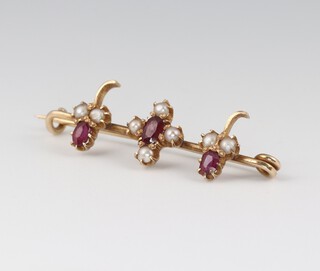 A gold testing as 14ct ruby and pearl set bar brooch, 3.5cm, 2.5g