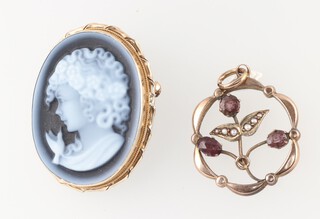 An hardstone carved cameo style brooch contained in a gilt metal mount, together with a gilt metal floral pendant