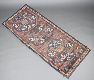 A blue, white and red ground Persian runner with 3 octagon to the centre 190cm x 81cm 