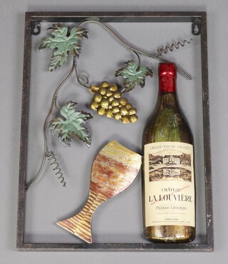 A tubular and pressed metal wall sculpture in the form of a wine bottle with glass and grapes 46cm h x 35cm 
