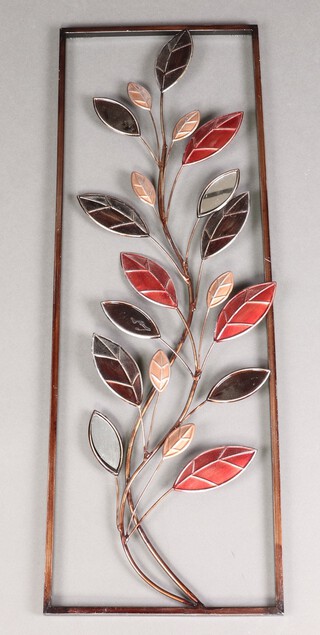 A pressed metal wall sculpture in the form of reeds 90cm h x 31cm w 