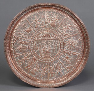 An Eastern embossed copper charger decorated figures 57cm diam. 