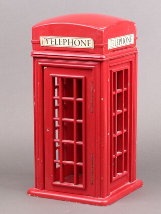 A red painted trinket box in the form of a telephone kiosk 38cm h x 17cm w x 17cm d  (handle to door missing) 