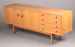 Times Furnishing, a mid-century teak sideboard fitted double cupboard enclosed by panelled doors flanked by 4 drawers, raised on turned supports 72cm h x 127cm w x 44cm d (water and contact marks in places)