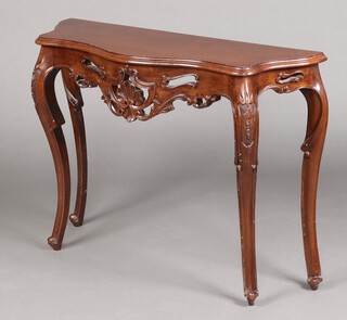 A Victorian style carved and pierced mahogany console table, raised on cabriole supports 78cm h x 118cm w x 35cm d 