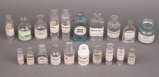 A collection of glass pharmacy bottles with paper labels 