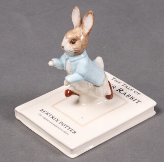 A Beswick Beatrix Potter figure - Peter on his Book 
