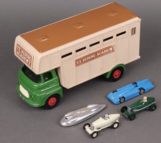 A Tri-ang metal and plastic TT Riding Academy horse box and 4 Lledo model racing cars boxed 