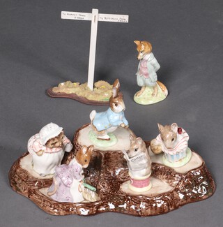 A Beswick Beatrix Potter 5 figure stand in the form of tree stumps and a signpost together with a collection of 6 Beatrix Potter figures - Peter Rabbit, Mrs Tittlemouse with gold stamps, Foxy Whiskered Gentleman, Hunca Munca Sweeping, Mrs Tiggywinkle and the Tailor of Gloucester with brown stamps 