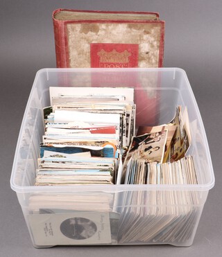 An album of coloured and black and white postcards and a collection of loose postcards, contained in a plastic box 