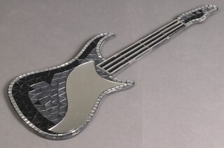 A wall mirror in the form of an electric guitar 89cm x 33cm 