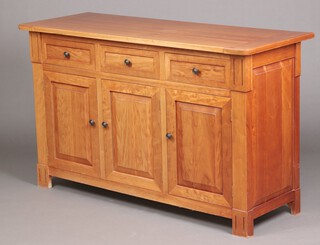 A hardwood sideboard fitted 3 drawers above cupboards, raised on square supports 90cm h x 149cm w x 55cm d (ring mark to centre)