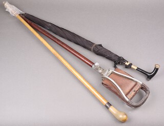 A shooting stick, a cane and an umbrella 