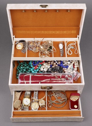 A quantity of costume jewellery including wristwatches, beads, necklaces, etc, contained in a white gilt jewellery box 