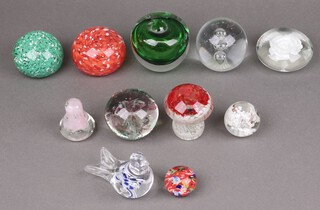 A paperweight in the form of a toadstool and a collection of other paperweights