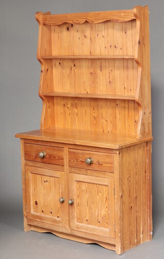 A pine dresser fitted shelves above drawers and double cupboard 183cm h x 106cm w x 46cm d 