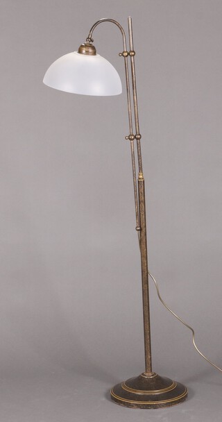A metal adjustable standard lamp raised on a circular base