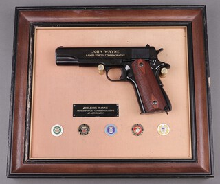 A Franklin Mint The John Wayne Armed Forces Commemorative replica Beretta,  framed 