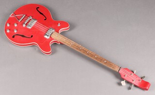 A red Baldwin 704 bass guitar, circa 1965. On this model the brand name was on the pick guard but this has been removed, as have the frets, which was a fashionable thing to do by bass players in the late 60's and 1970's.