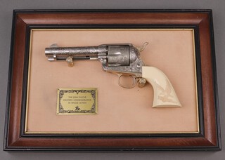 A Franklin Mint "The John Wayne Western Commemorative" replica Colt 45 single action revolver, framed 