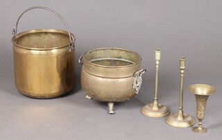 A circular copper pale with polished steel handle 28cm, circular twin handled coal bin, pair of brass candlesticks and a brass vase 