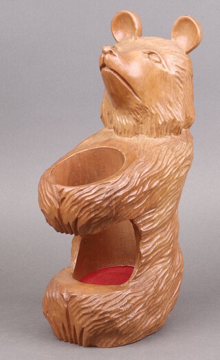 A Swiss "Black Forest" carved bottle holder in the form of a bear 36cm 